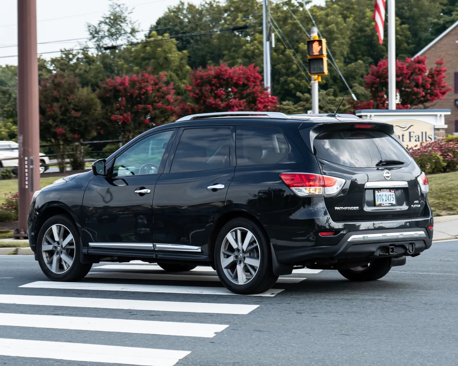 Black Nissan Pathfinder SUV, rear three-quarter view