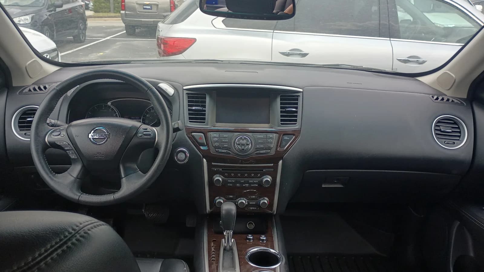 2016 Nissan Pathfinder interior, dashboard with black leather and woodgrain trim