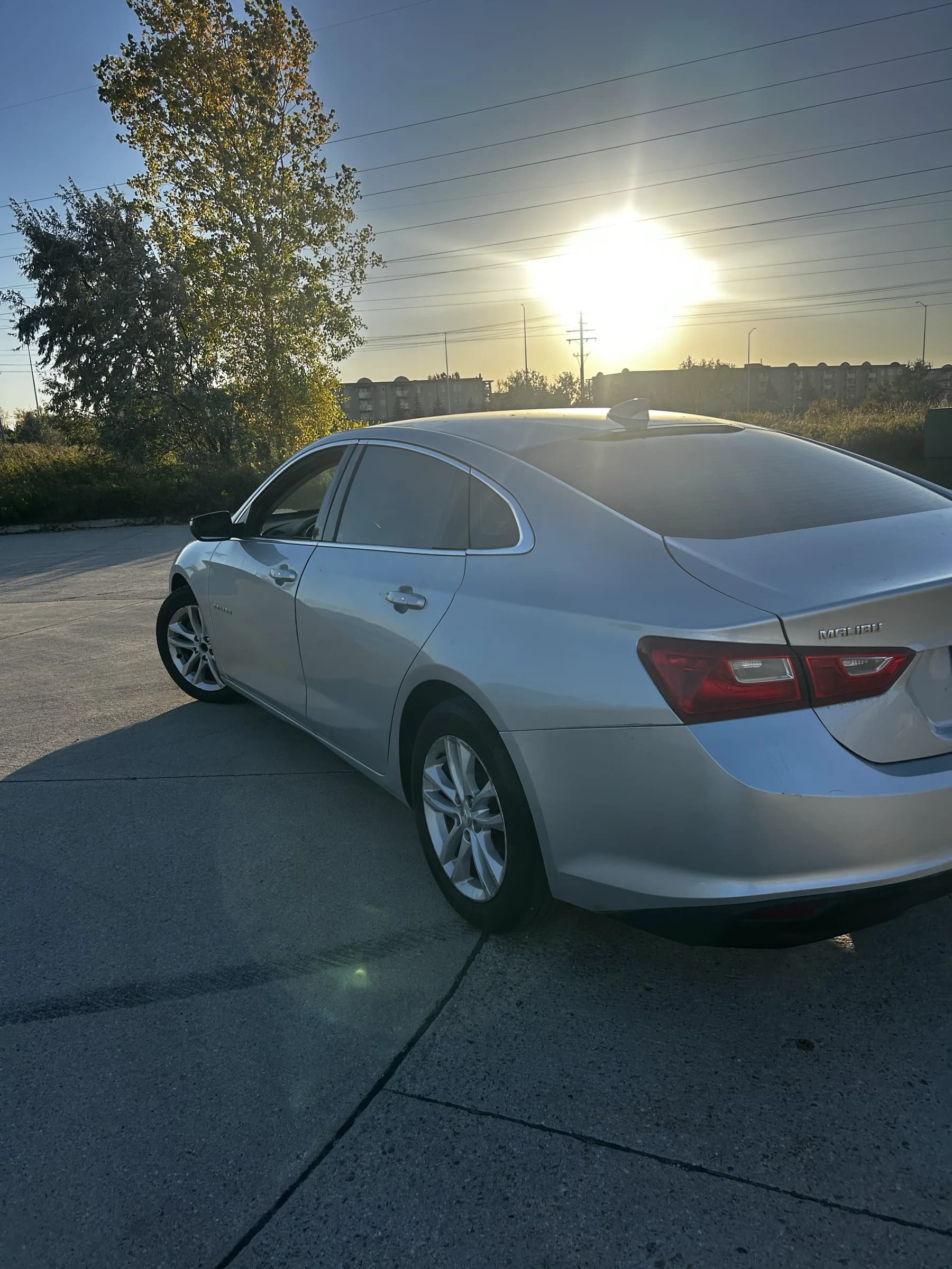 Silver 2018 Chevrolet Malibu LT sedan, rear three-quarter view