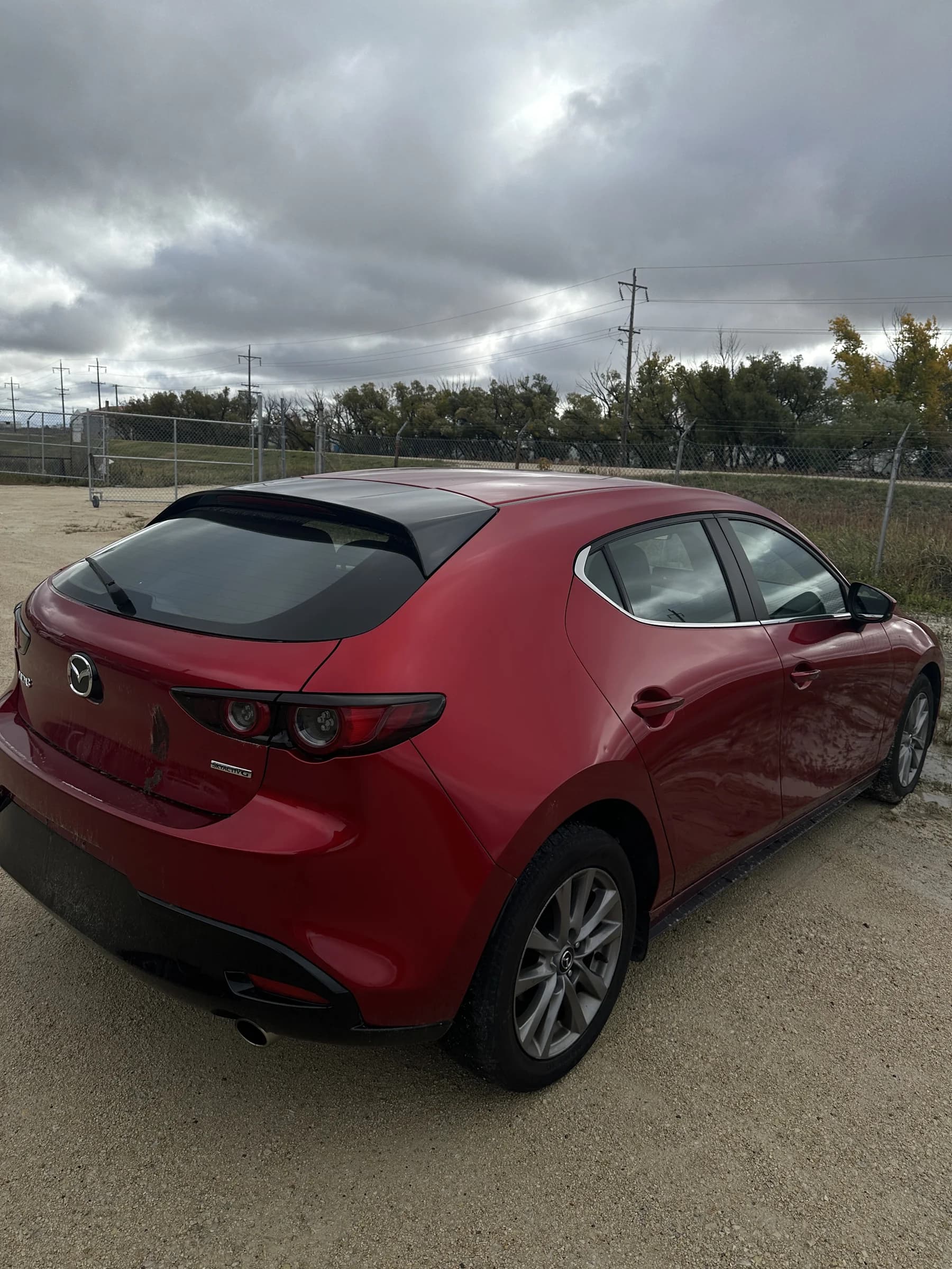 Red 2021 Mazda3 Sport GS hatchback, rear three-quarter view