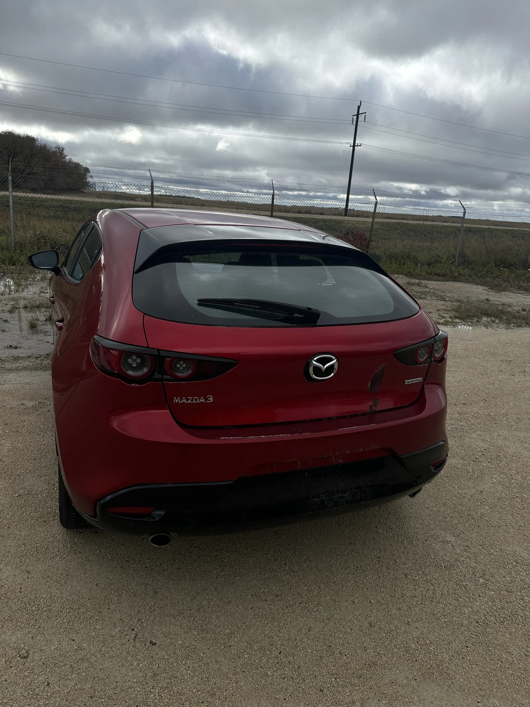 Red 2021 Mazda3 Sport GS hatchback, rear view