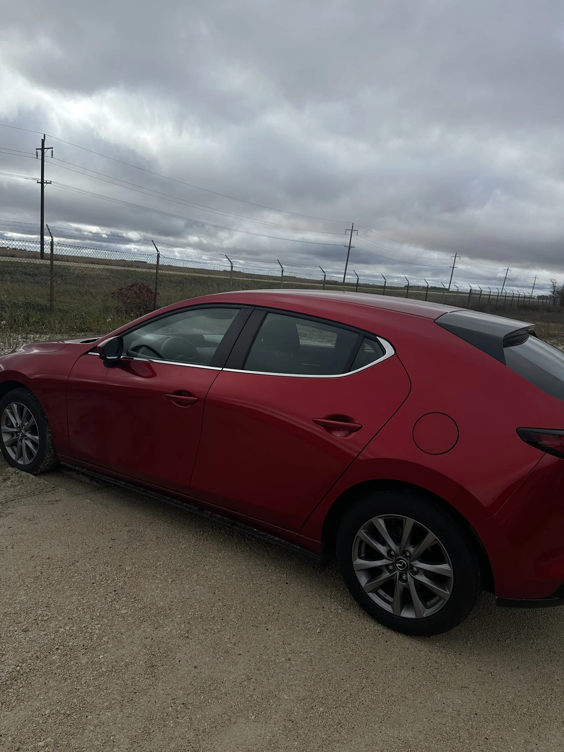 Red 2021 Mazda3 Sport GS hatchback, passenger-side view
