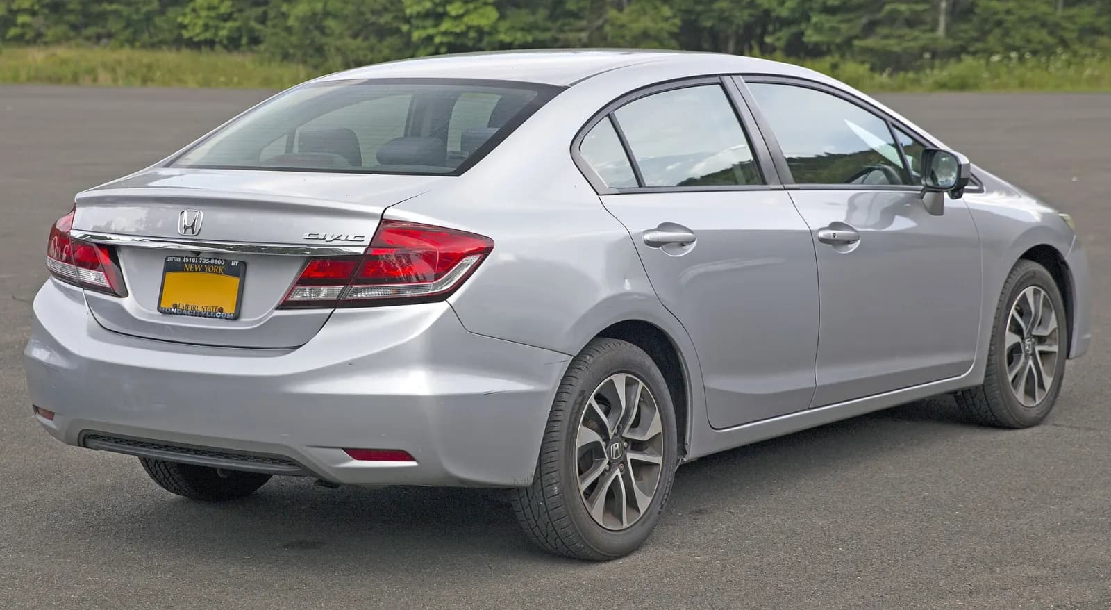 Silver 2015 Honda Civic EX sedan, rear three-quarter view
