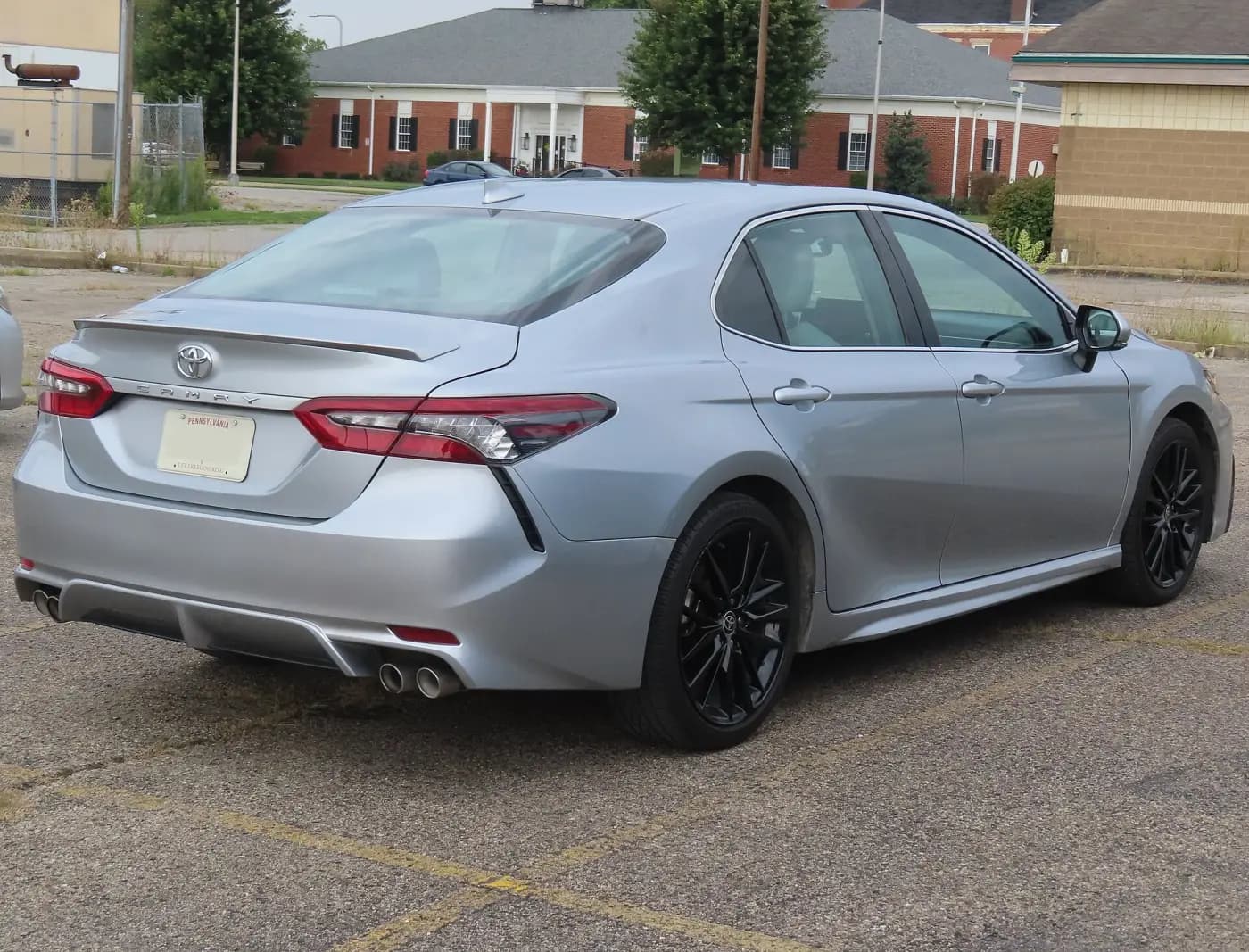 Silver Toyota Camry XSE sedan, rear three-quarter view